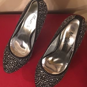 Black high heeled shoes with white rhinestones.